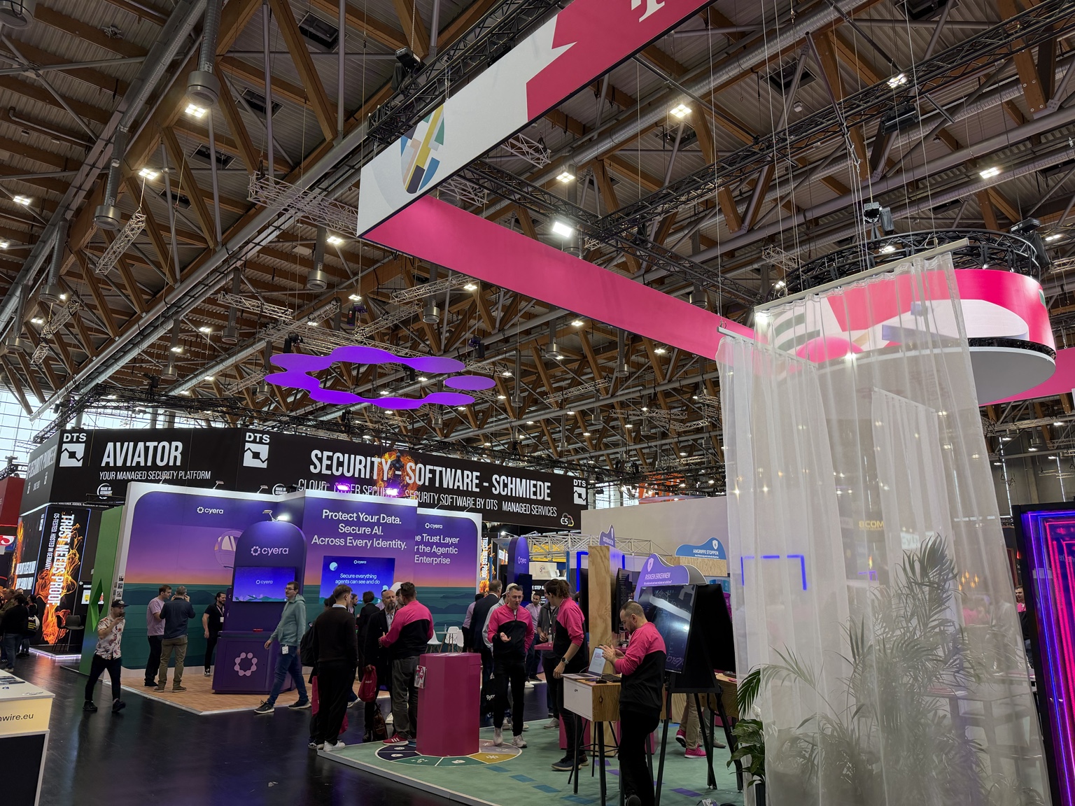 Visitors and technology exhibition stands inside a hall at NürnbergMesse during it-sa 2026