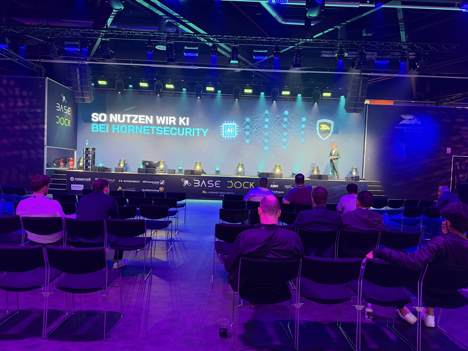 Audience and presentation on AI in IT security at Hornetsecurity’s BASE DOCK