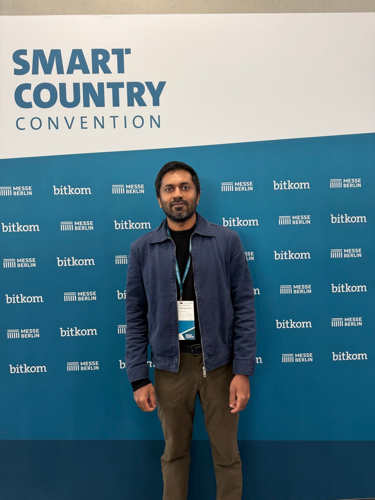 Portrait in front of the Smart Country Convention backdrop with Messe Berlin and bitkom lettering