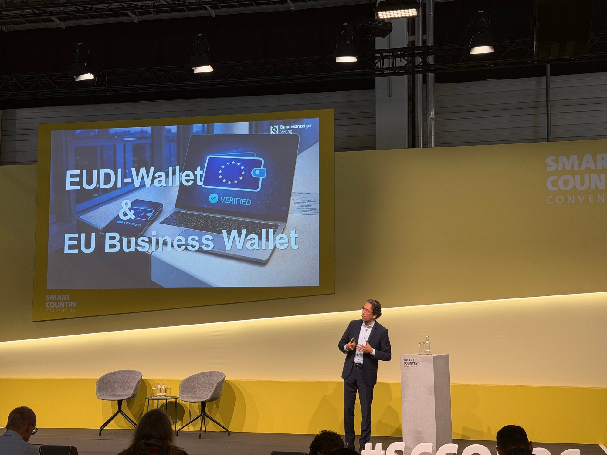 Speaker presenting EUDI Wallet and EU Business Wallet on a stage at SCCON 2026